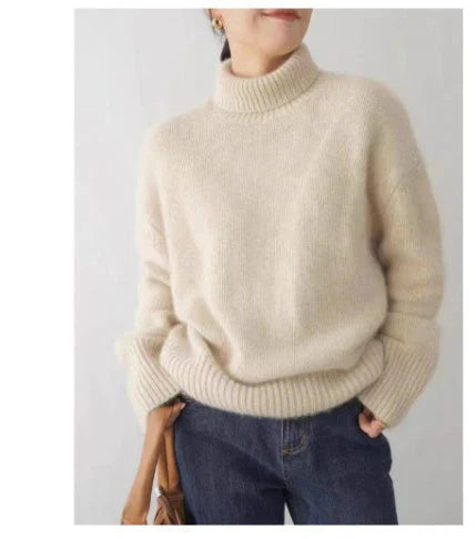 Back view of a women's loose-fitting oversized turtleneck sweater, showcasing its relaxed drape
