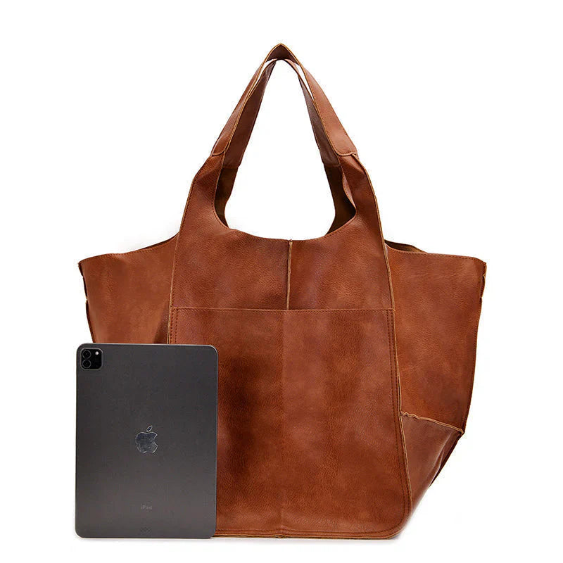 Women's oversized vintage brown leather shoulder bag, front view with flap closure, everyday accessory