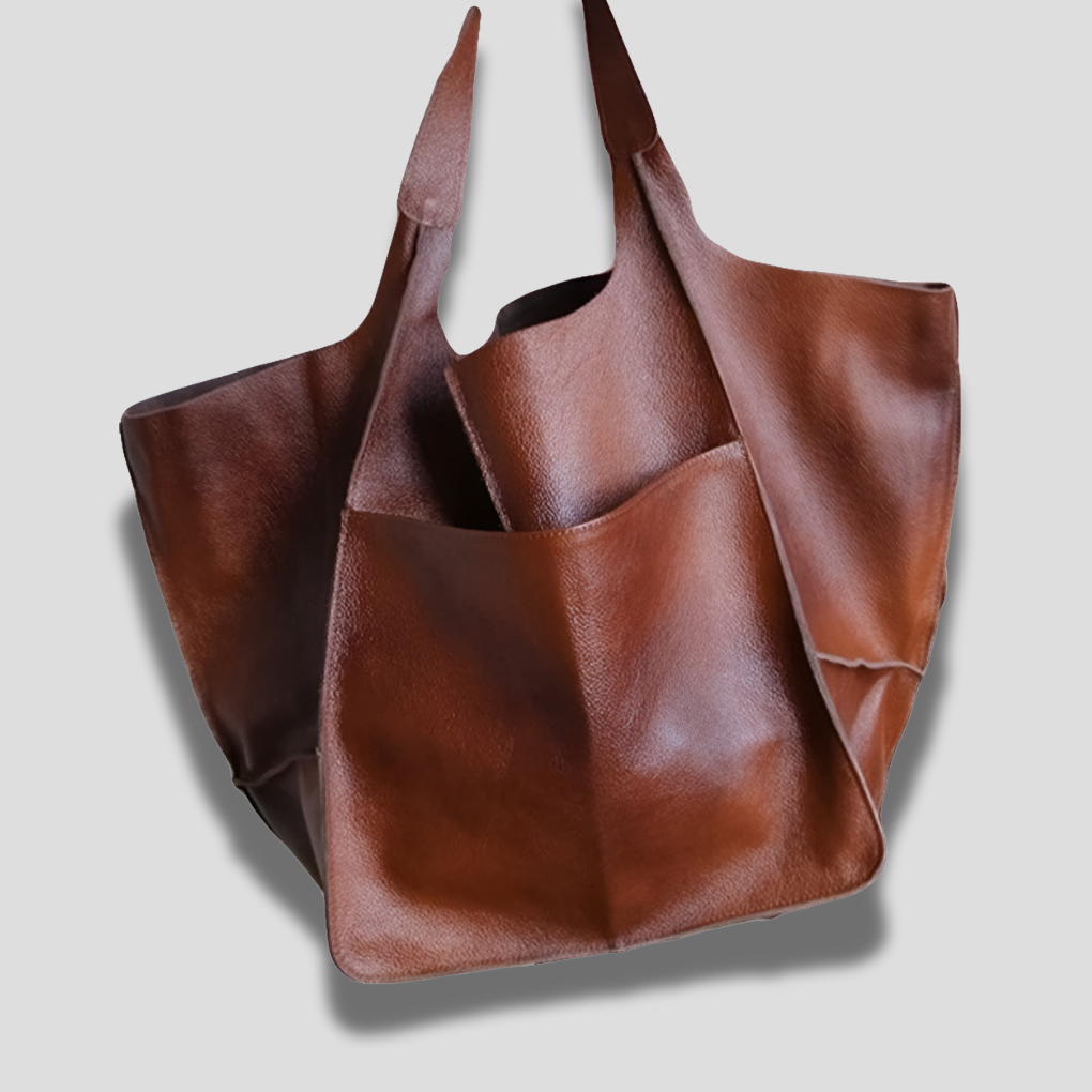Close-up of vintage leather texture on women's oversized shoulder bag, highlighting material quality