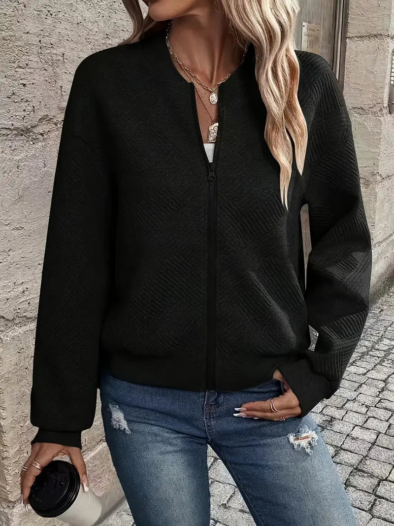 Woman smiling wearing a cozy patterned full zip knit cardigan, side view, comfort fashion