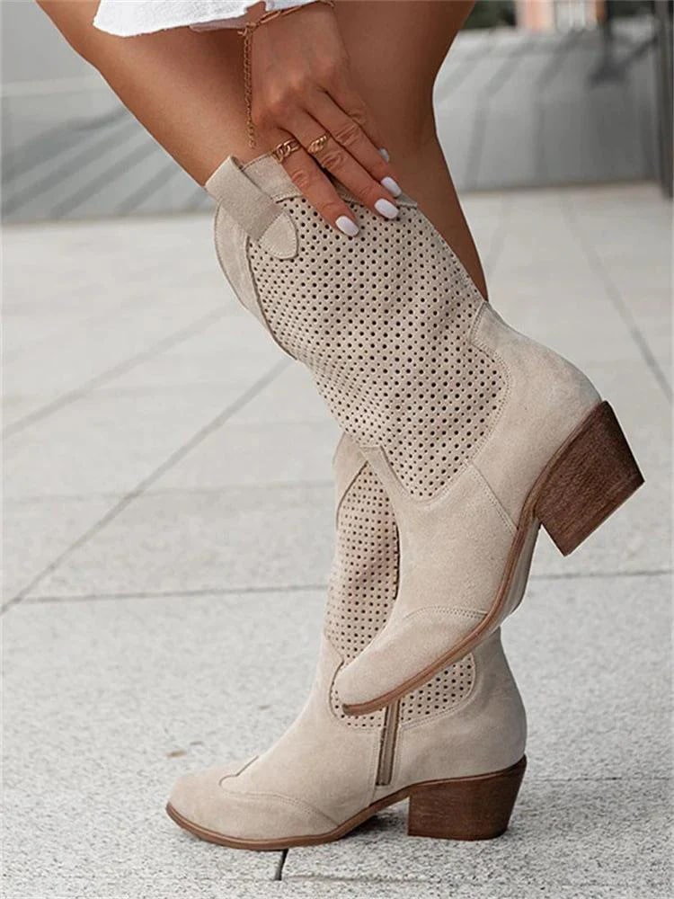 Women's perforated western ankle boots with block heel, pointed toe, and pull-on style for casual wear.