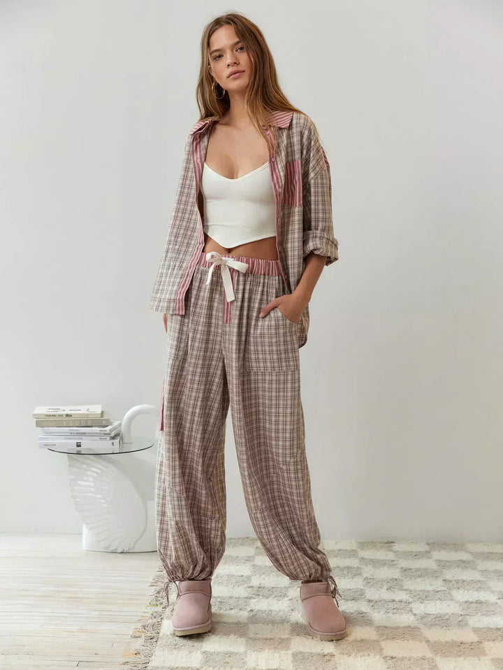 Full-body image of a woman wearing a pink and blue plaid matching set, featuring a top and shorts