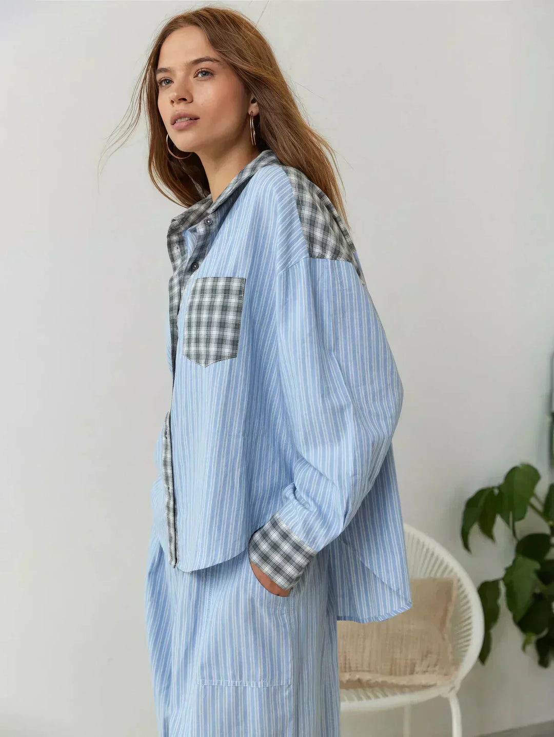 Back view of a women's comfortable pink and blue plaid matching set, highlighting its relaxed fit