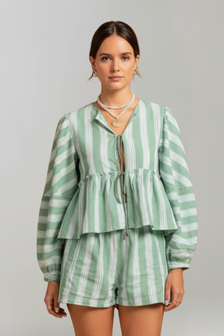 Model wearing a women's green striped long sleeve shorts set, showcasing its comfortable fit.