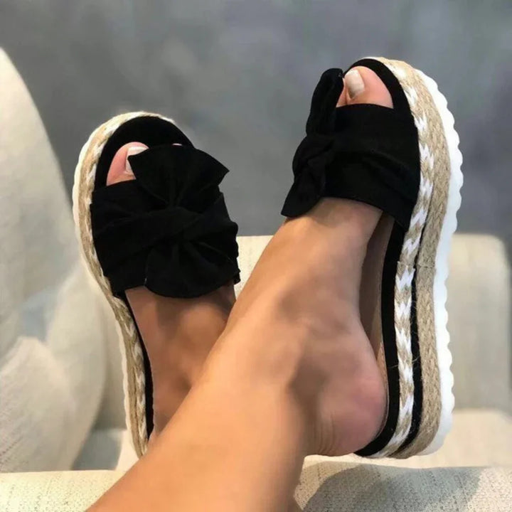 Stylish black bow platform slide sandals for women, great for summer fashion footwear