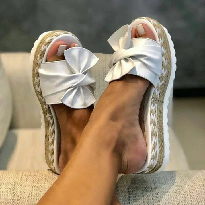 Pair of comfy blue bow platform slide sandals for women, ideal casual summer shoes