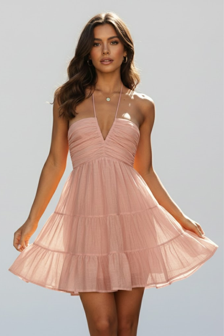 Orange halter neck mini dress with tiered skirt, an ideal vacation outfit or casual summer dress.
