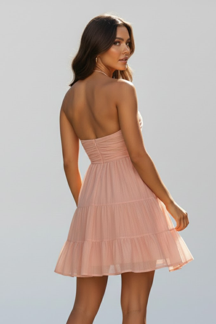 Model wearing a flattering orange tiered halter neck mini dress, suitable for various summer occasions.
