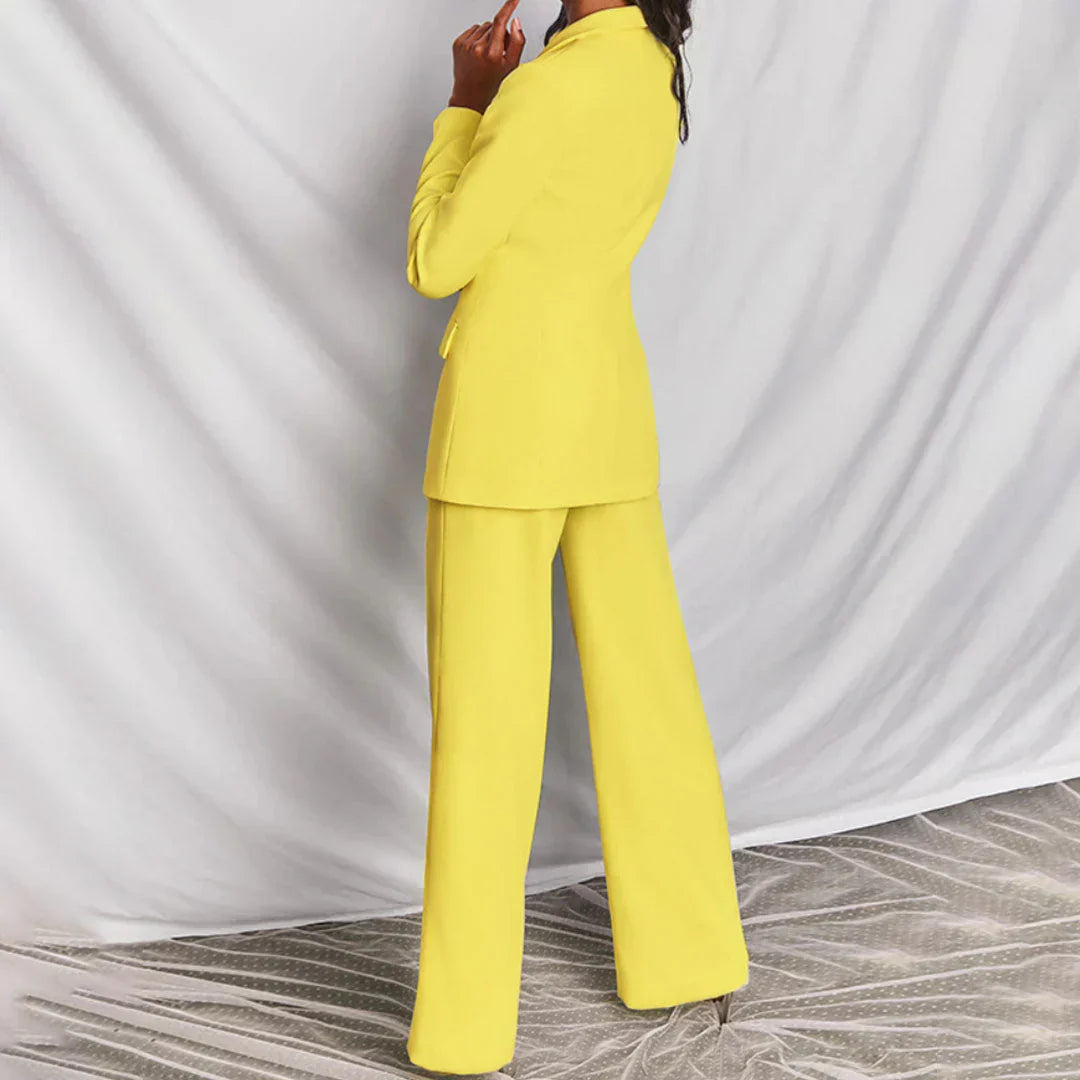 Stylish salmon two-piece powersuit for women, featuring a longline blazer & wide-leg trousers.