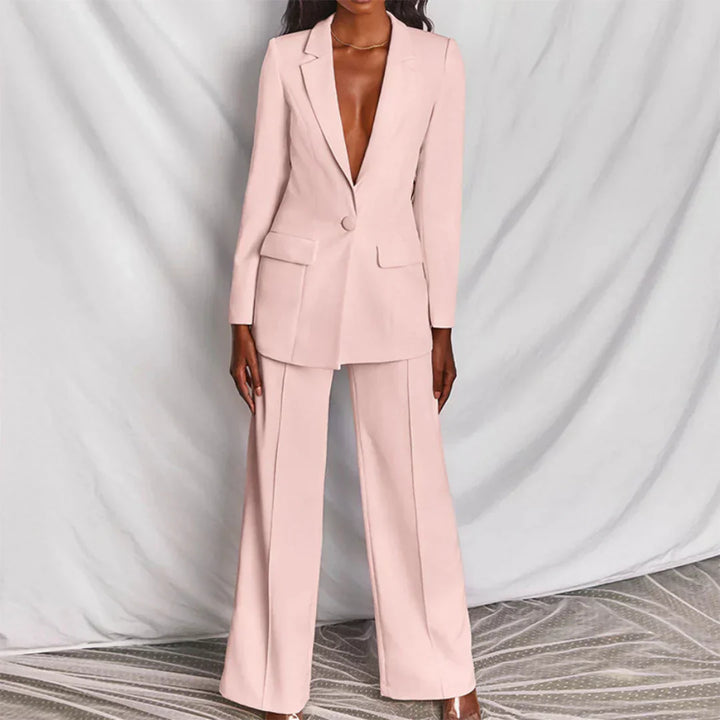 Structured womenswear: longline blazer & wide-leg trousers in a vibrant coral hue.