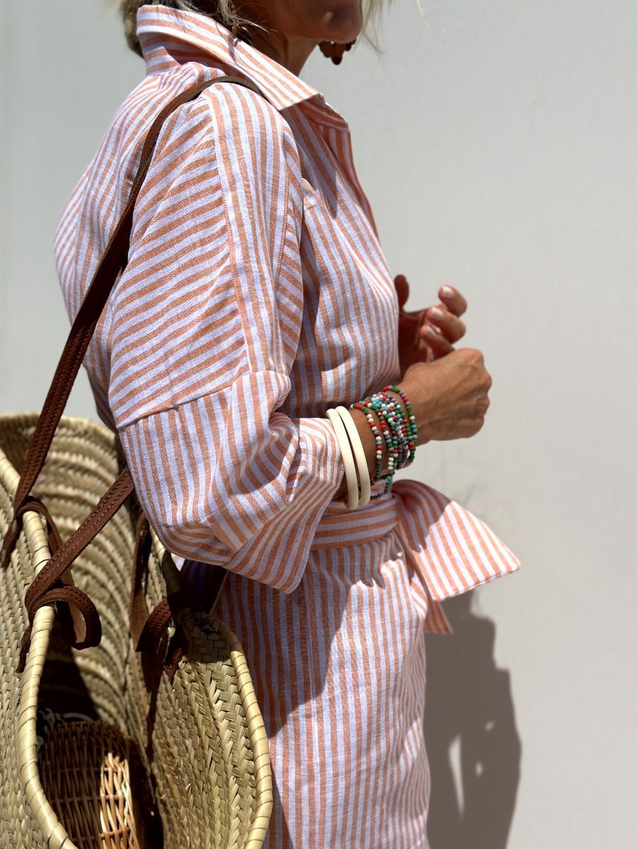 Women's fashionable pink striped button down midi dress, ideal for work or casual outings.