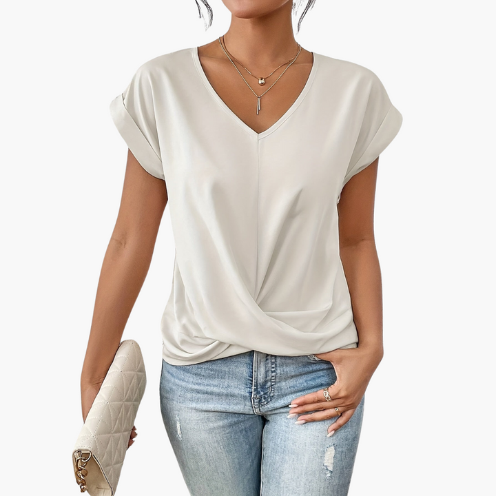 Model wearing a green V-neck draped casual top, showcasing its relaxed fit and versatile style