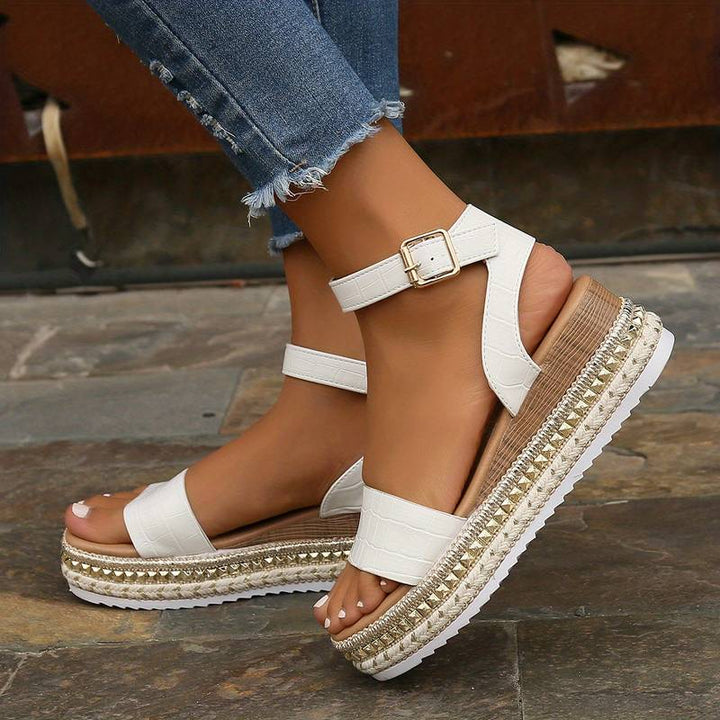 Stylish women's open-toe platform sandals with an elegant ankle strap, ideal for summer outfits.