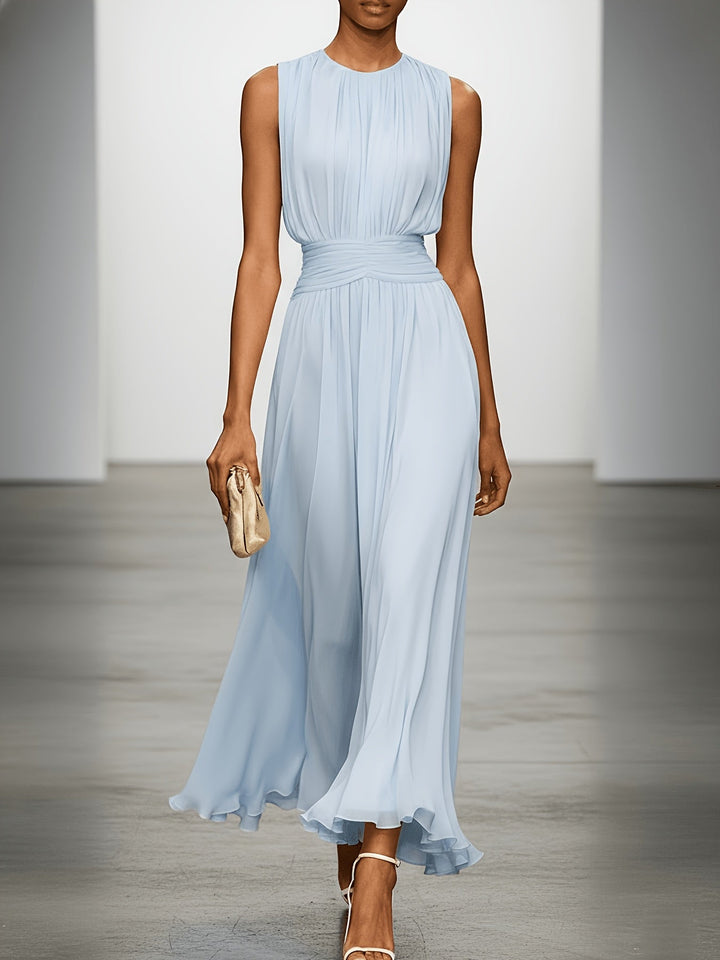 Elegant sleeveless maxi dress, pleated skirt & ruched waist for wedding guest or evening wear.
