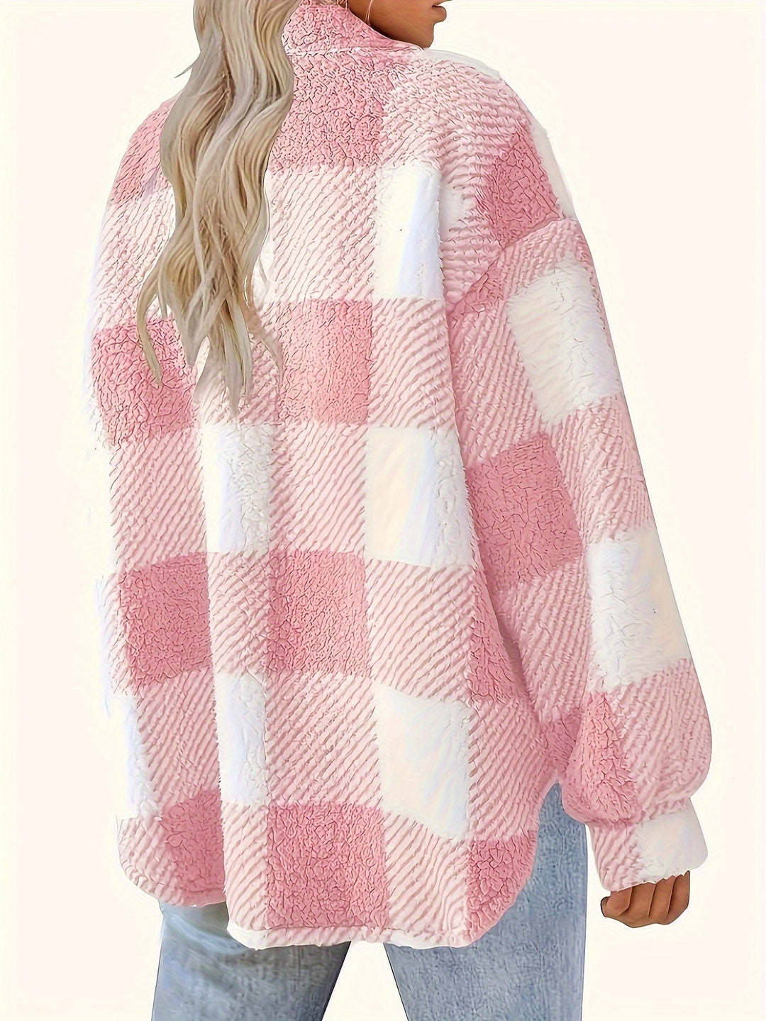 Close-up of the plaid pattern and plush texture of a women's button-up jacket, winter coat