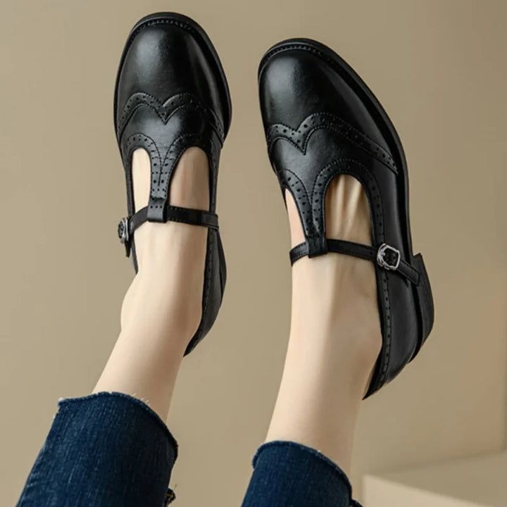 Pair of brown T-strap Mary Janes, women's polished leather flats with brogue detailing