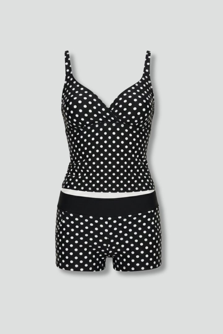 Women's polka dot wrap top tankini and black swim shorts set, ideal for flattering beachwear.