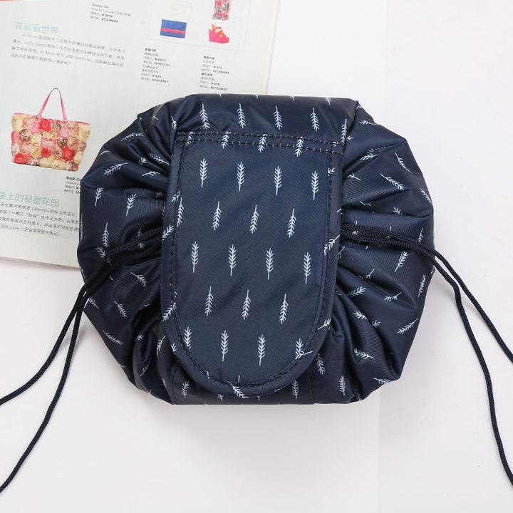 Women's foldable cosmetic travel bag with secure drawstring closure.