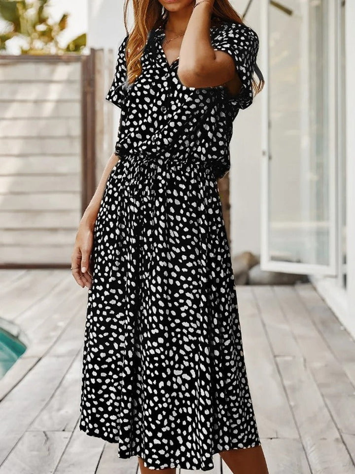 Simple yet elegant women's printed midi dress, short sleeves & adjustable waist for effortless style.