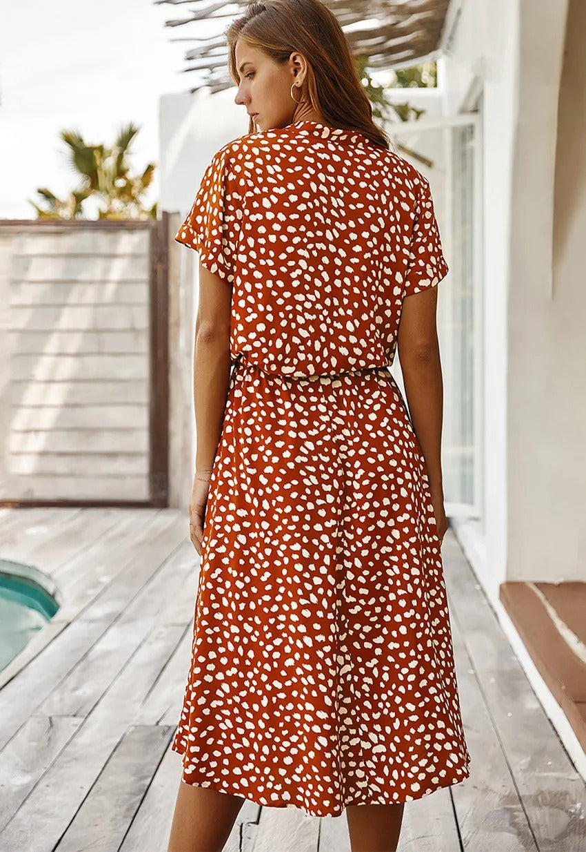 Lightweight summer midi dress for women, vibrant print, short sleeves, & adjustable waist.