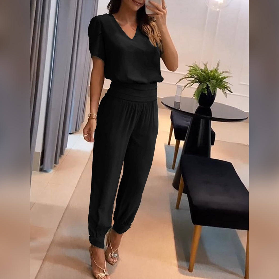 Women's printed V-neck wide leg jumpsuit with tie waist, perfect for comfortable and stylish summer fashion.