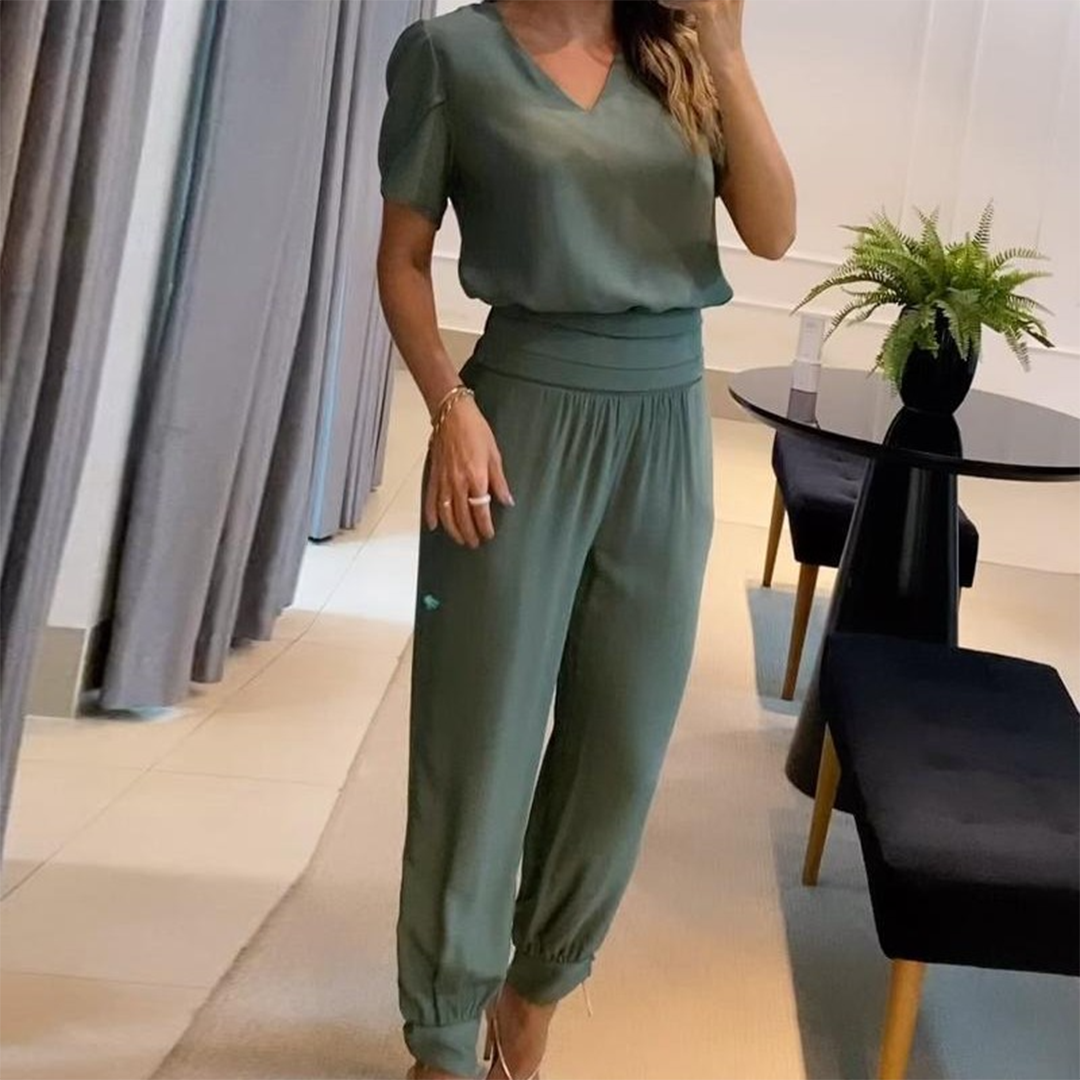Relaxed fit women's V-neck printed wide leg jumpsuit with a tie waist for comfortable, effortless style.