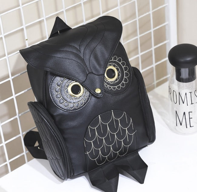 Woman wearing a fashionable multi-pocket PU leather owl print backpack, perfect for daily style.