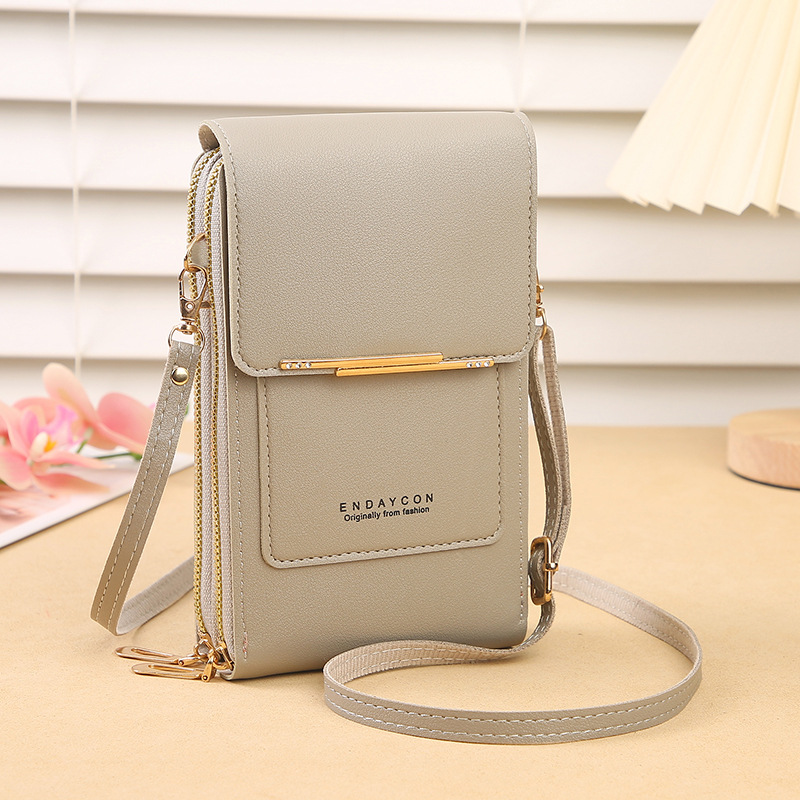 Elegant women's crossbody phone wallet bag with touchscreen access, a versatile daily accessory in faux leather.