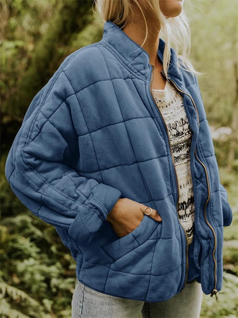 Lightweight women's zip-up quilted jacket, perfect outerwear for transitional weather.