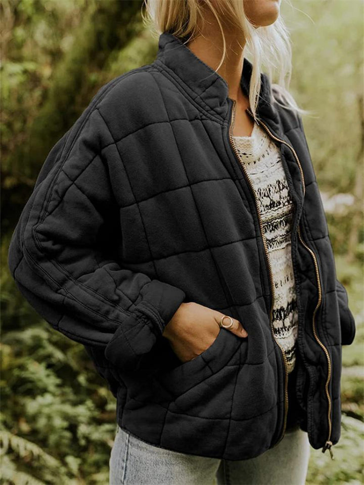 Fashionable women's quilted jacket with a stand-up collar, great for fall fashion.