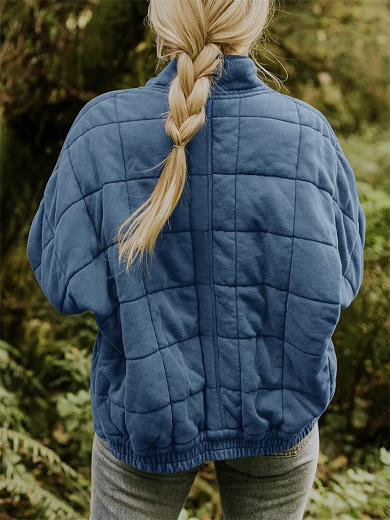 Elegant women's quilted zip-up jacket, offering comfort and style for cooler seasons.