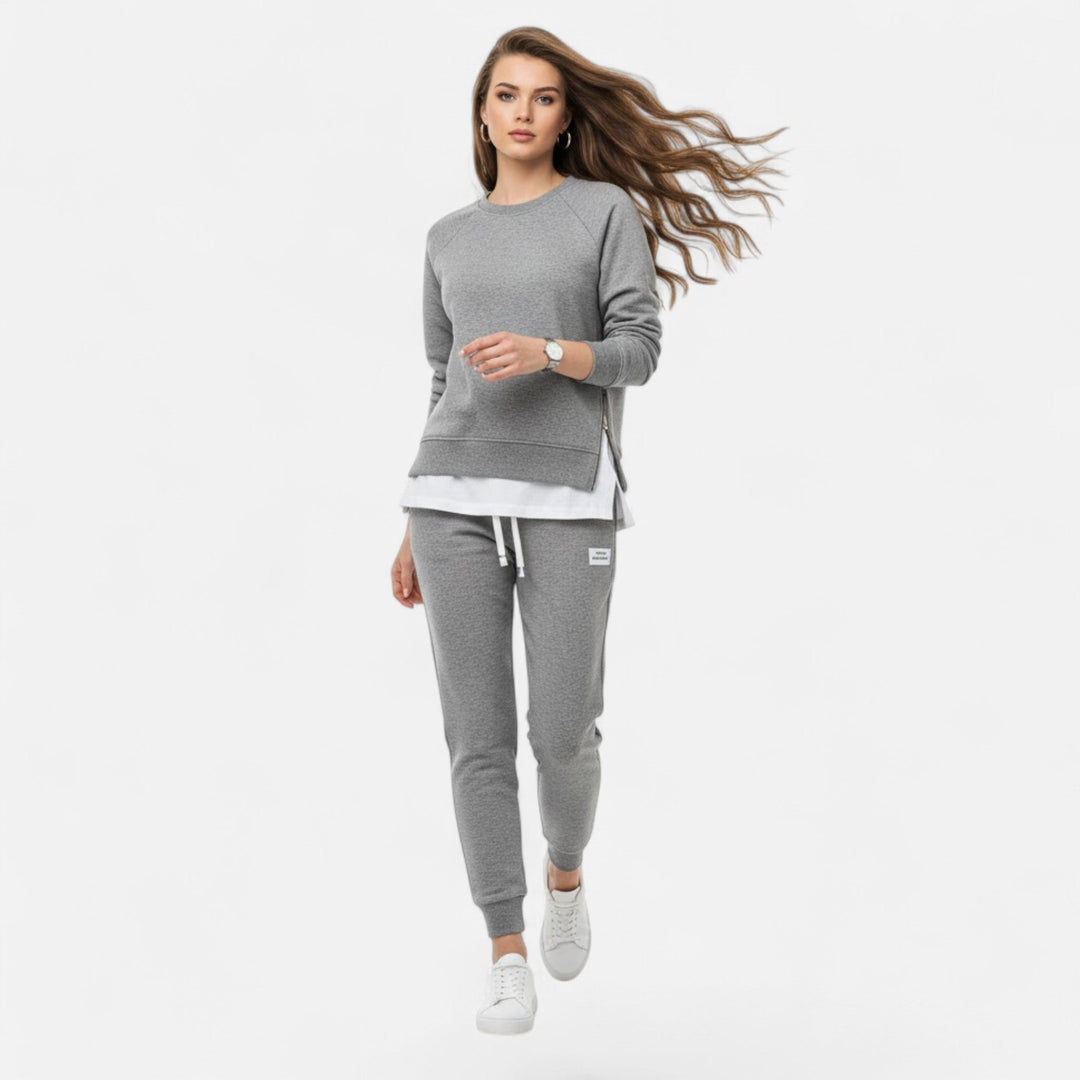 Elegant women's two-piece loungewear set with a slit sweatshirt & slim pants for comfortable, versatile wear.