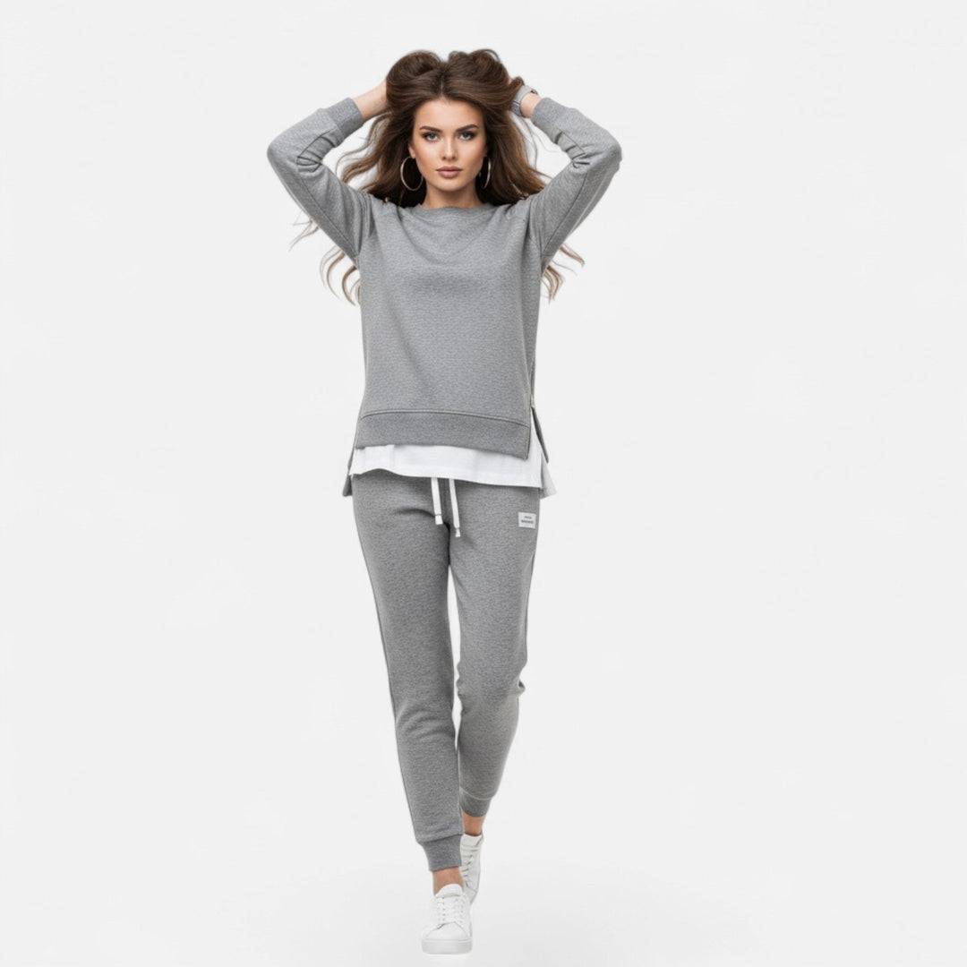 Modern women's matching set: comfortable slit sweatshirt & sleek slim pants for a casual yet chic look.