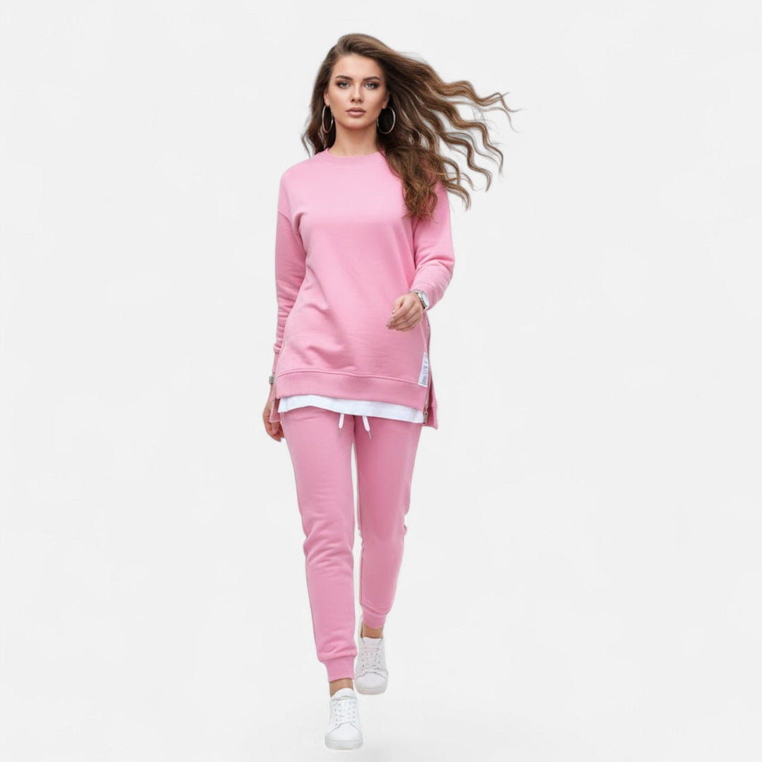Woman wearing a versatile two-piece matching set: a chic slit sweatshirt & comfortable slim pants. Casual elegant outfit.