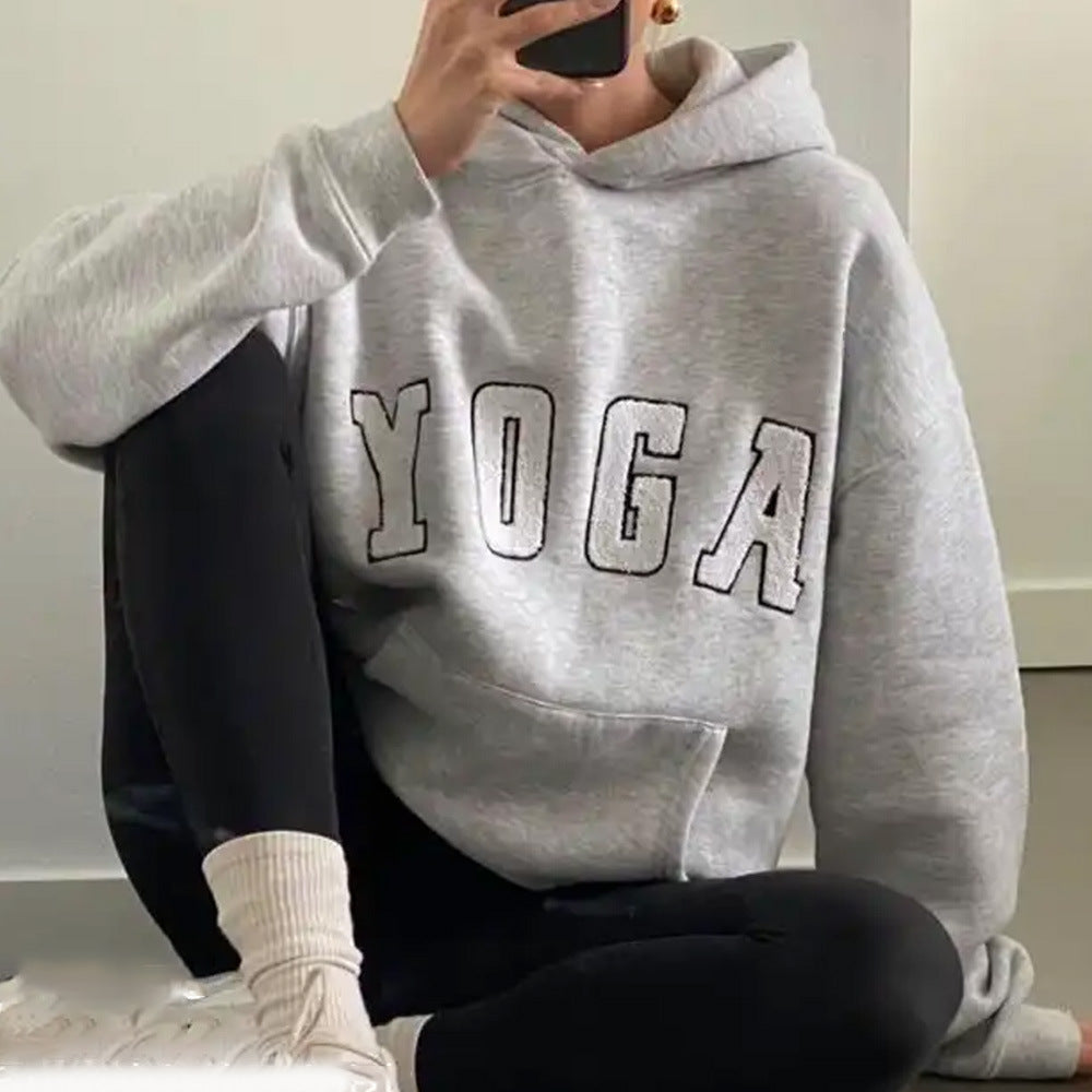 Stylish women's athletic hoodie with 'Yoga' graphic, great for relaxed fit activewear or daily wear.