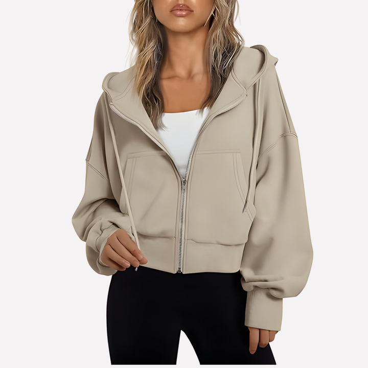 Women's fashion cropped zip jacket. Relaxed silhouette and drawstring hood for a modern casual look.