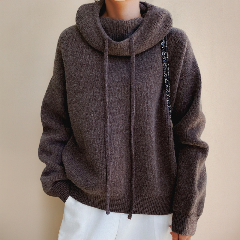 Female model wearing a soft, grey women's relaxed knit cowl neck hoodie for ultimate comfort and warmth.