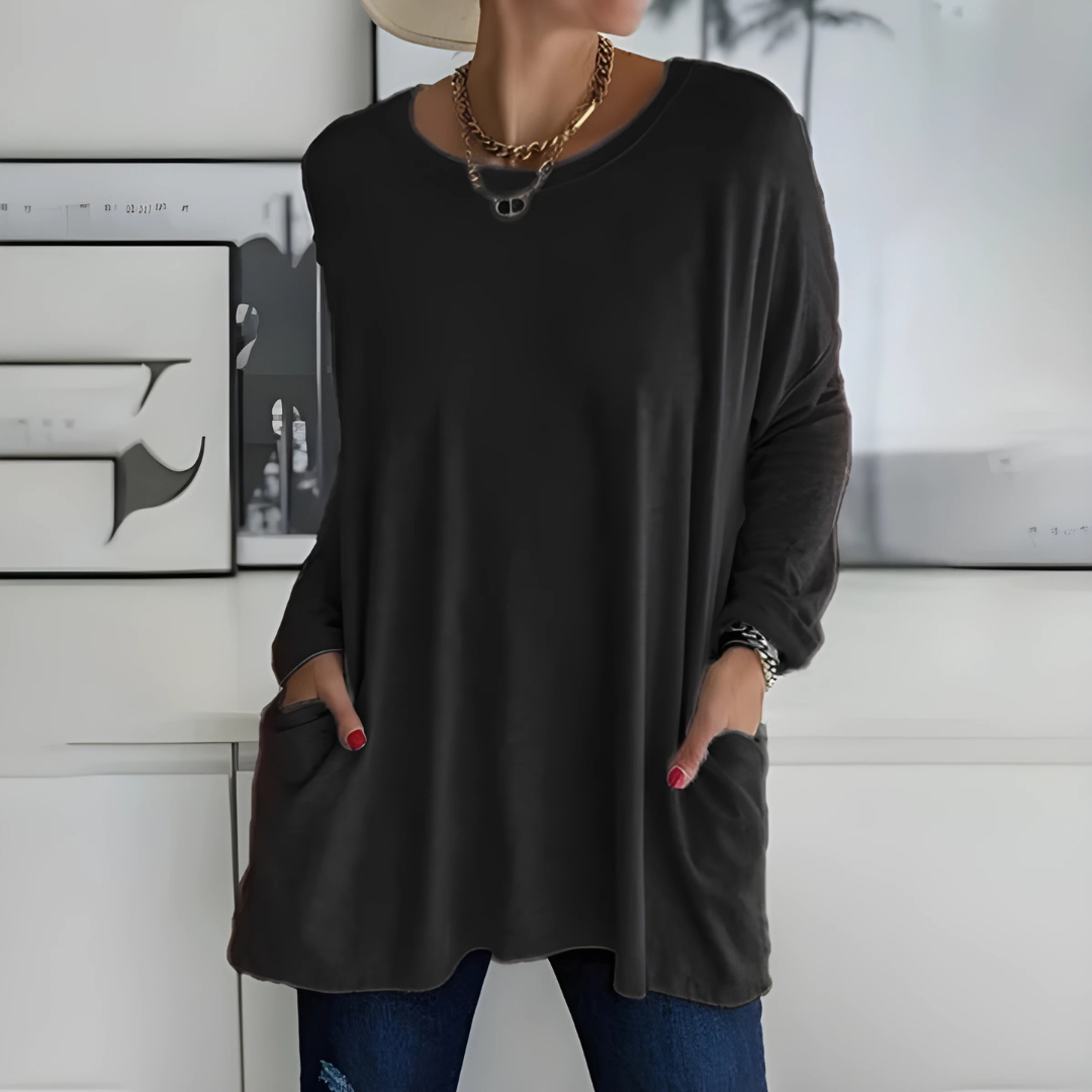 Women's relaxed fit long sleeve casual top in soft white fabric, ideal for everyday wear.