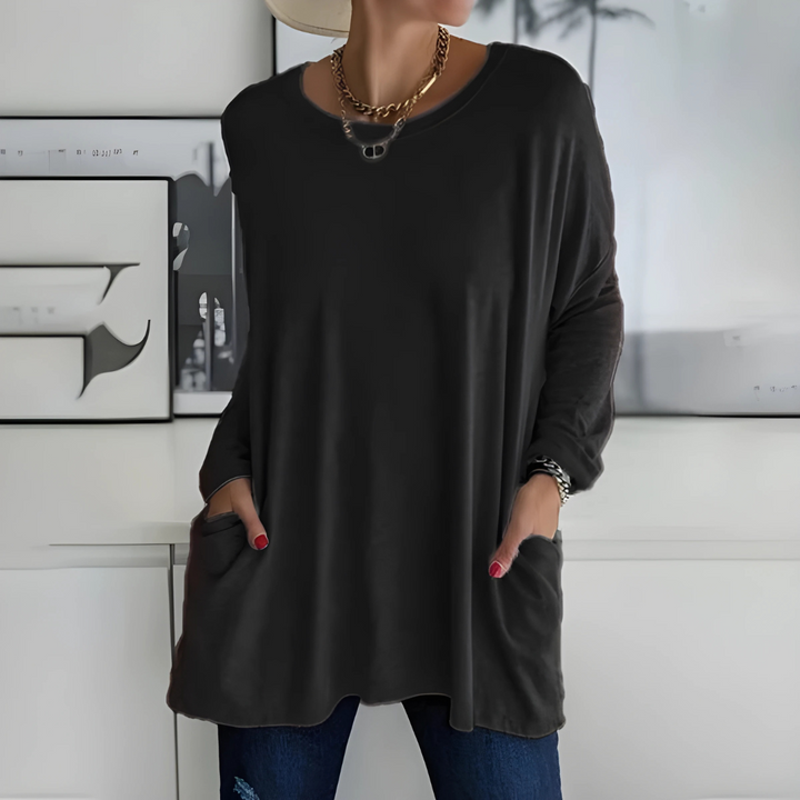 Women's relaxed fit long sleeve casual top in soft white fabric, ideal for everyday wear.