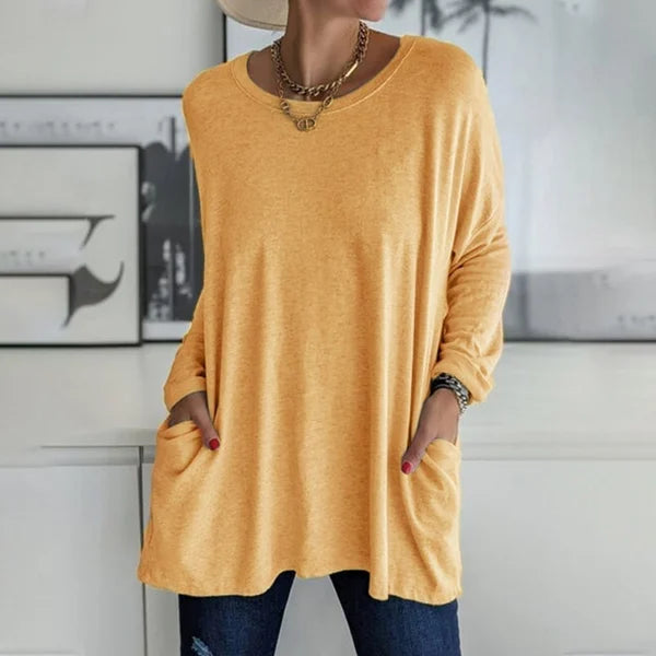 Casual women's long sleeve top, relaxed fit, paired with jeans for an everyday look.