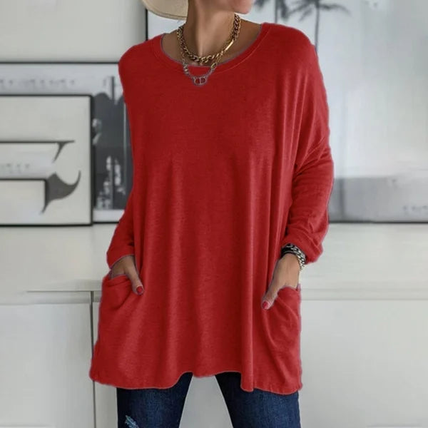 Folded women's relaxed fit long sleeve top, highlighting its soft material and easy care.