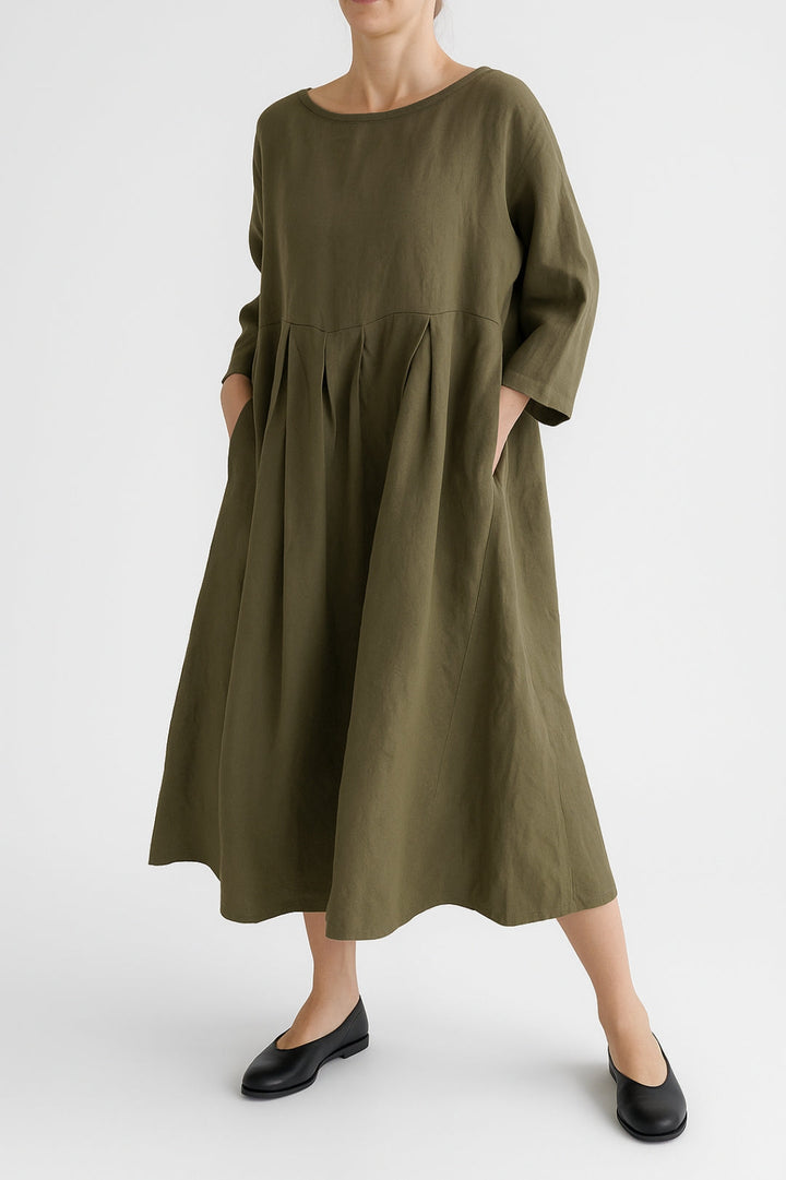Women's relaxed fit midi dress with elegant front pleats, perfect for a casual summer day.