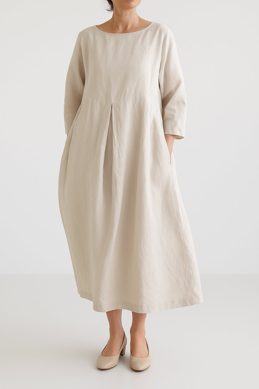 Stylish women's relaxed fit midi dress, showcasing chic front pleats for a touch of elegance.