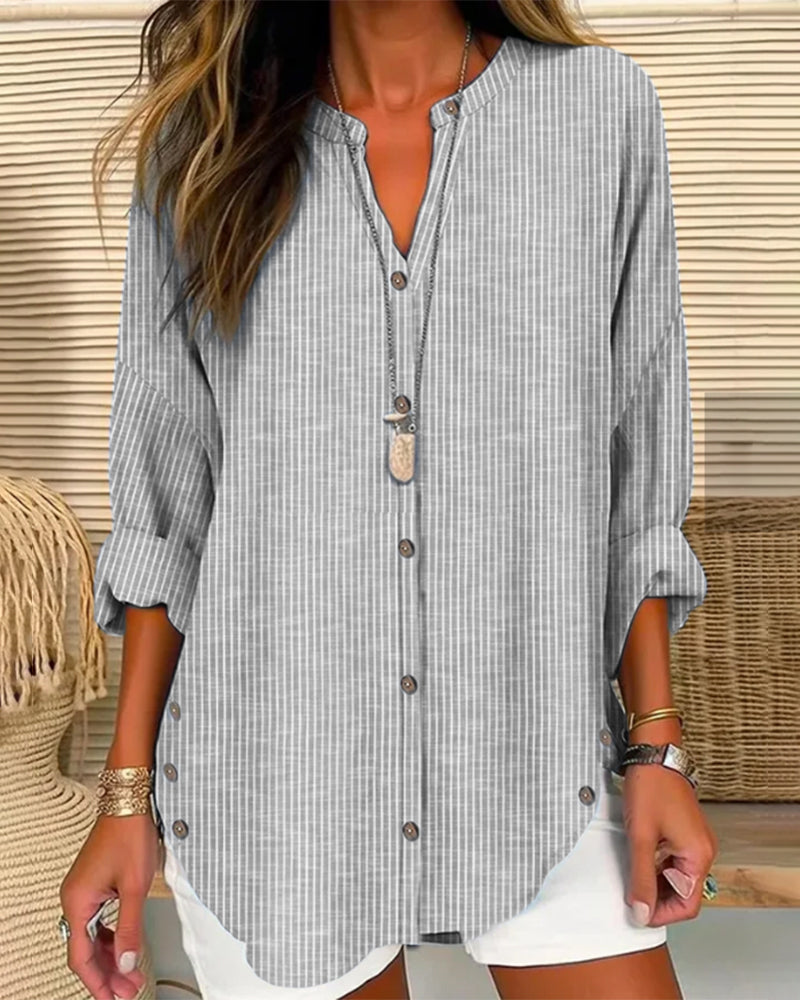 Model wearing a stylish women's relaxed striped blouse, ideal for casual summer fashion.