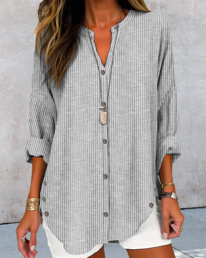 Detailed shot of the striped pattern on a women's relaxed button blouse, highlighting quality.