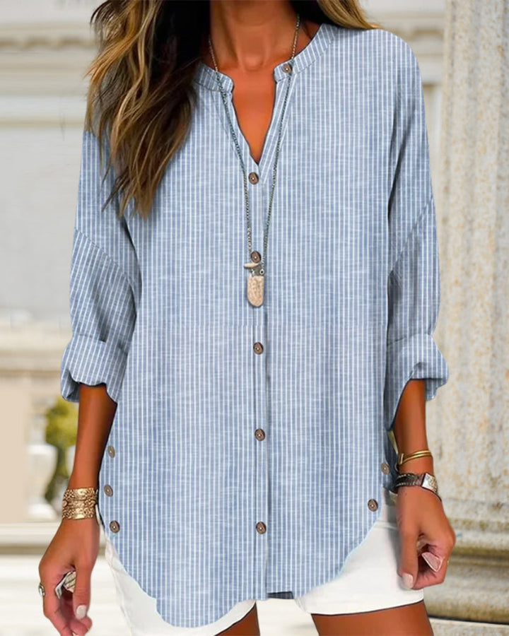 Relaxed fit women's blouse featuring a striped pattern and functional buttons.