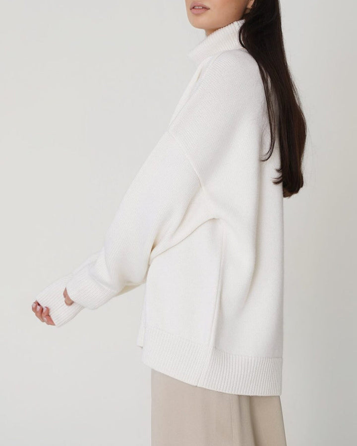 Model wearing a comfortable women's relaxed turtleneck sweater for casual spring outings