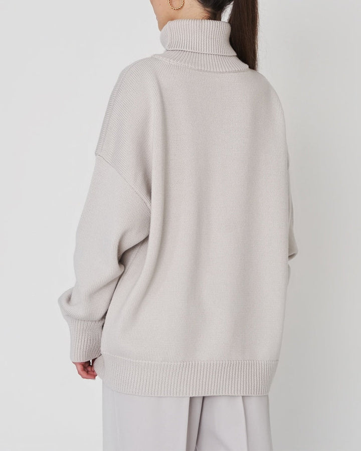 Textured image of a women's lightweight turtleneck sweater, great for spring fashion