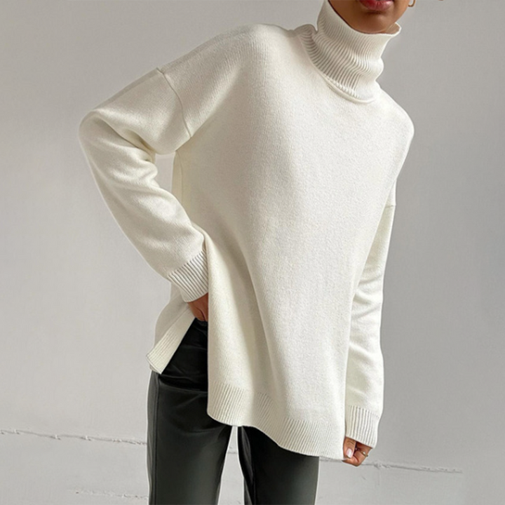 Women's relaxed fit turtleneck sweater with stylish side splits for a cozy, chic autumn look.