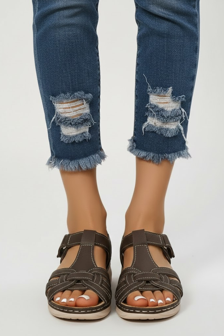 Close up of women's vintage-style buckle sandals, offering summer comfort and casual footwear fashion.